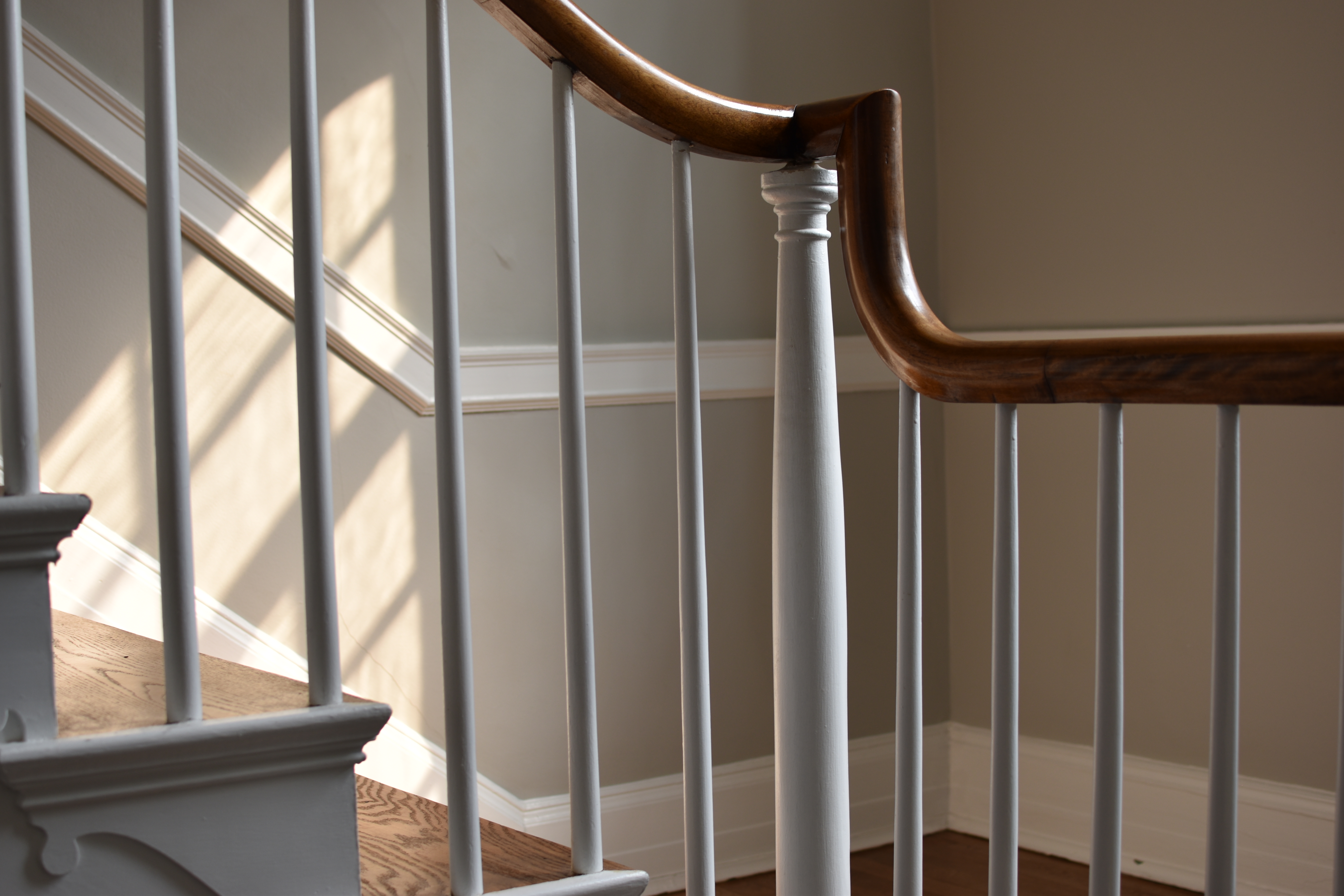 The stair hall at Robin Hill, morning light falling across original plaster